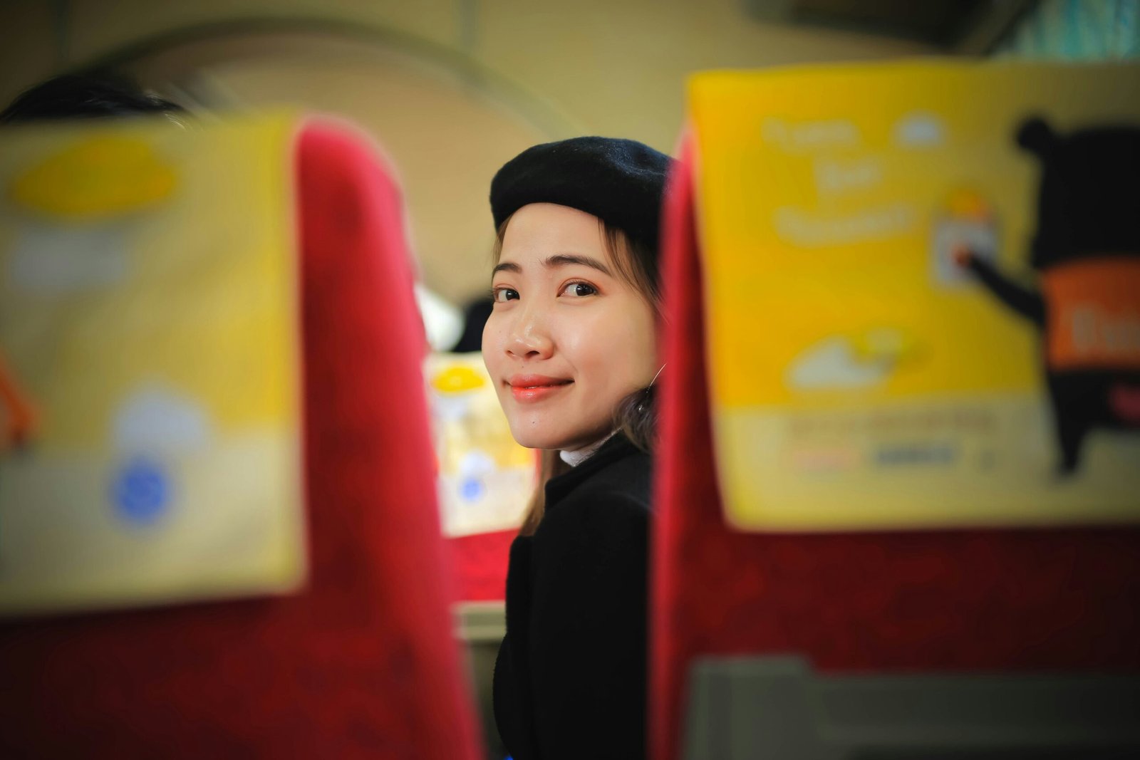 boy in black coat holding yellow paper