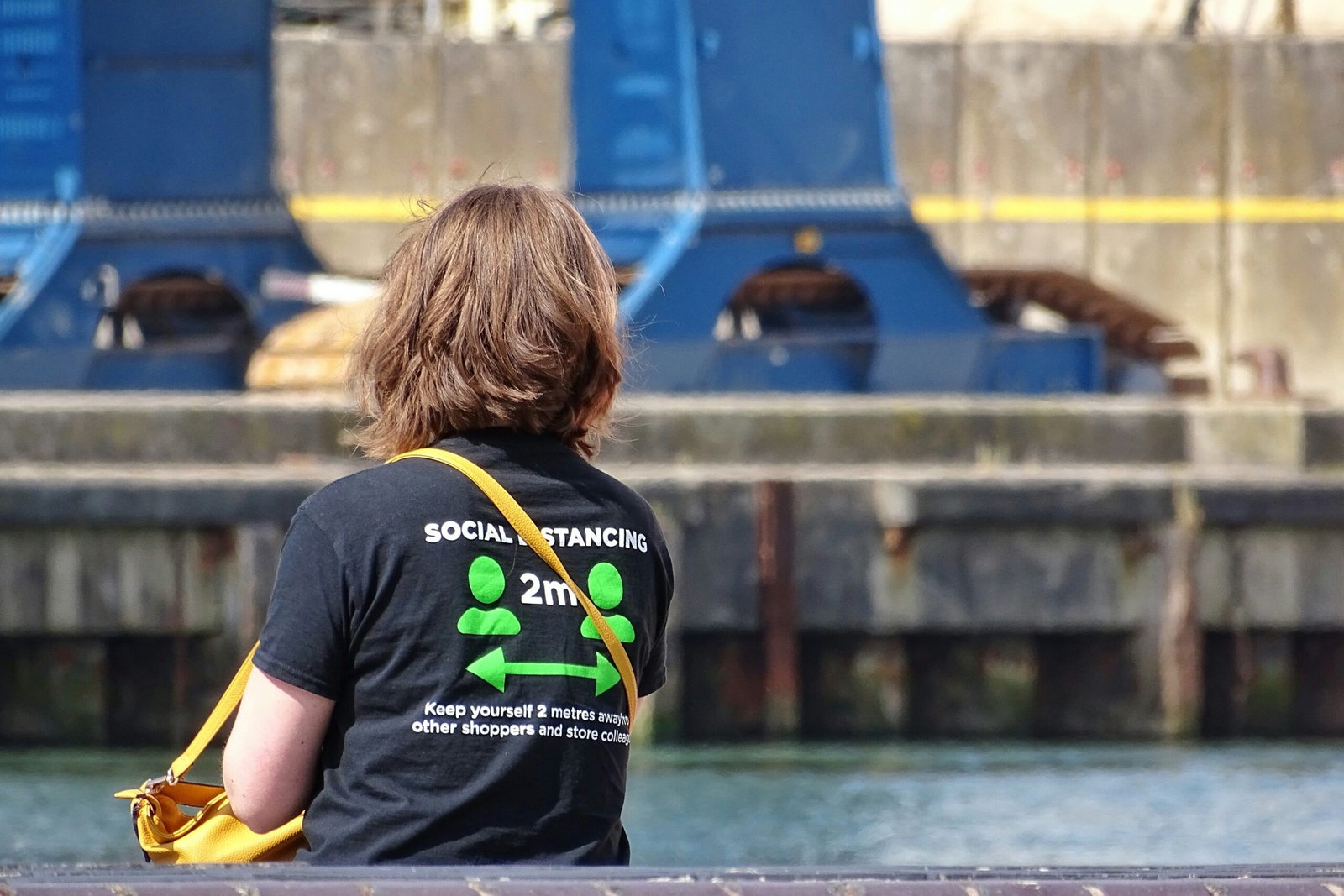 woman in black t-shirt sitting on yellow chair