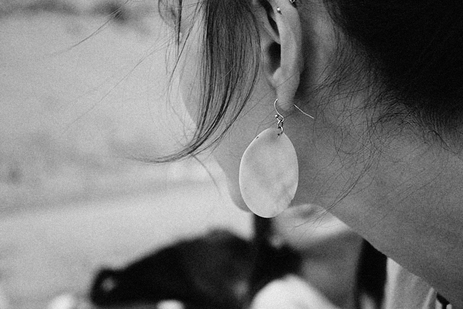 a close up of a person wearing a pair of earrings