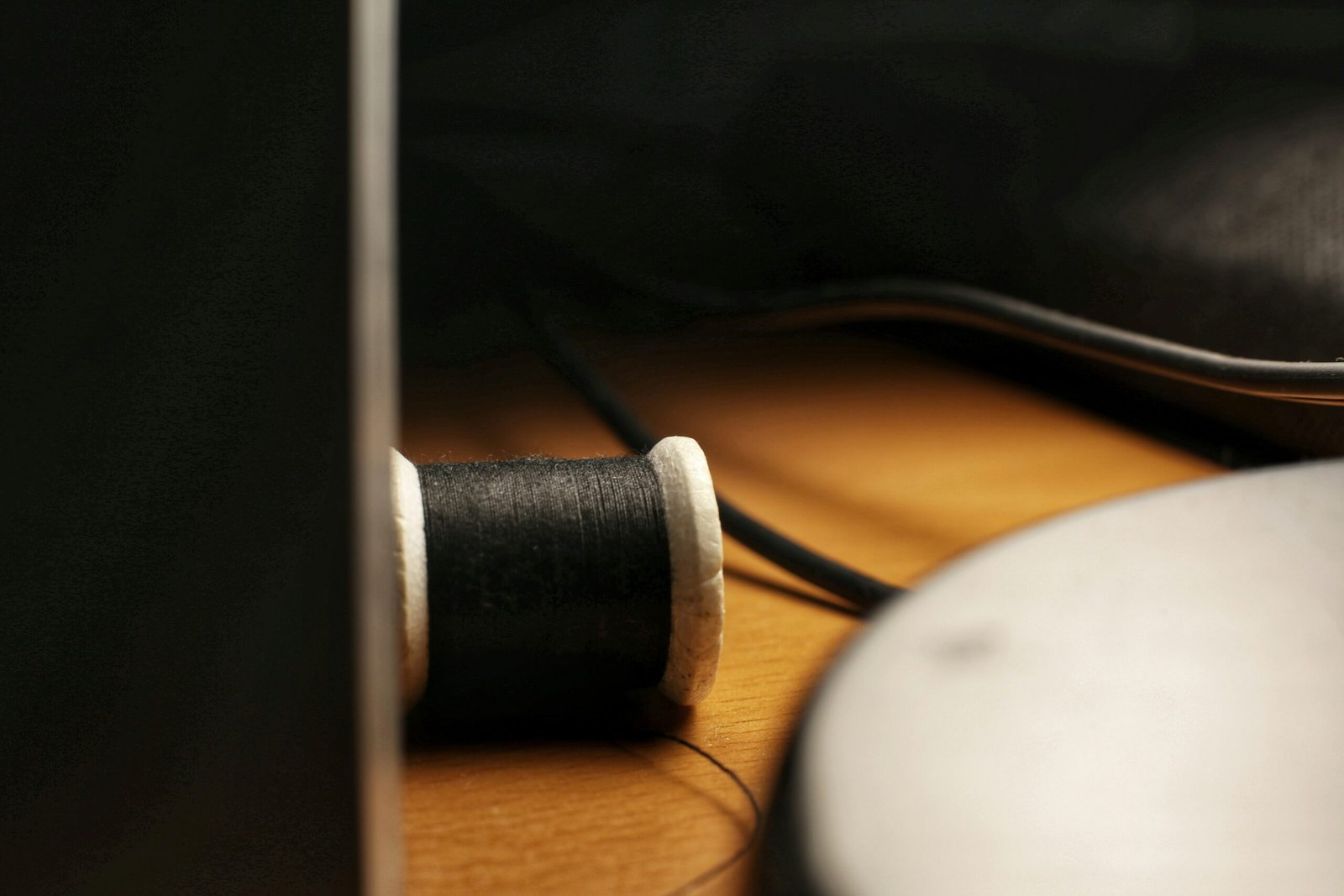 black thread on brown wooden table