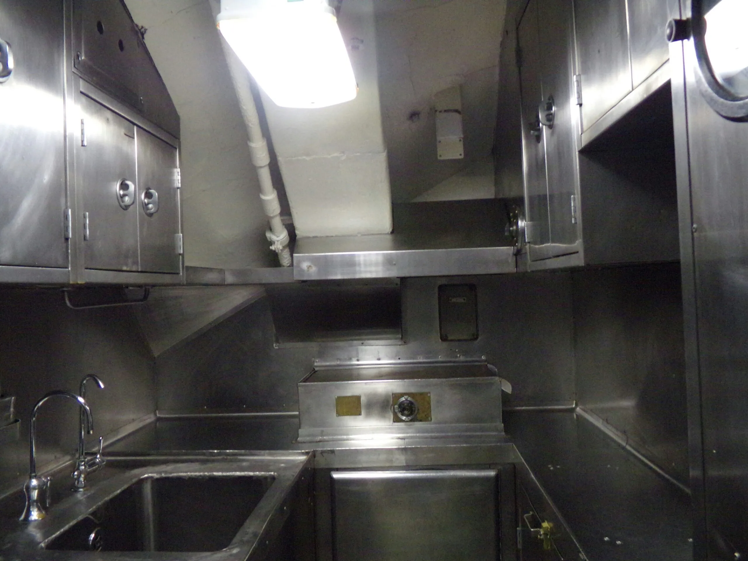 a stainless steel kitchen with a sink and a window