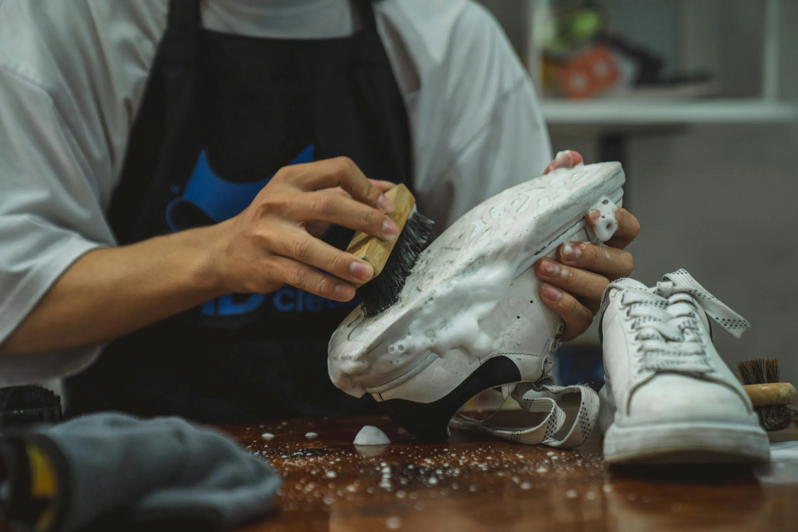 a person with a pair of shoes on a table