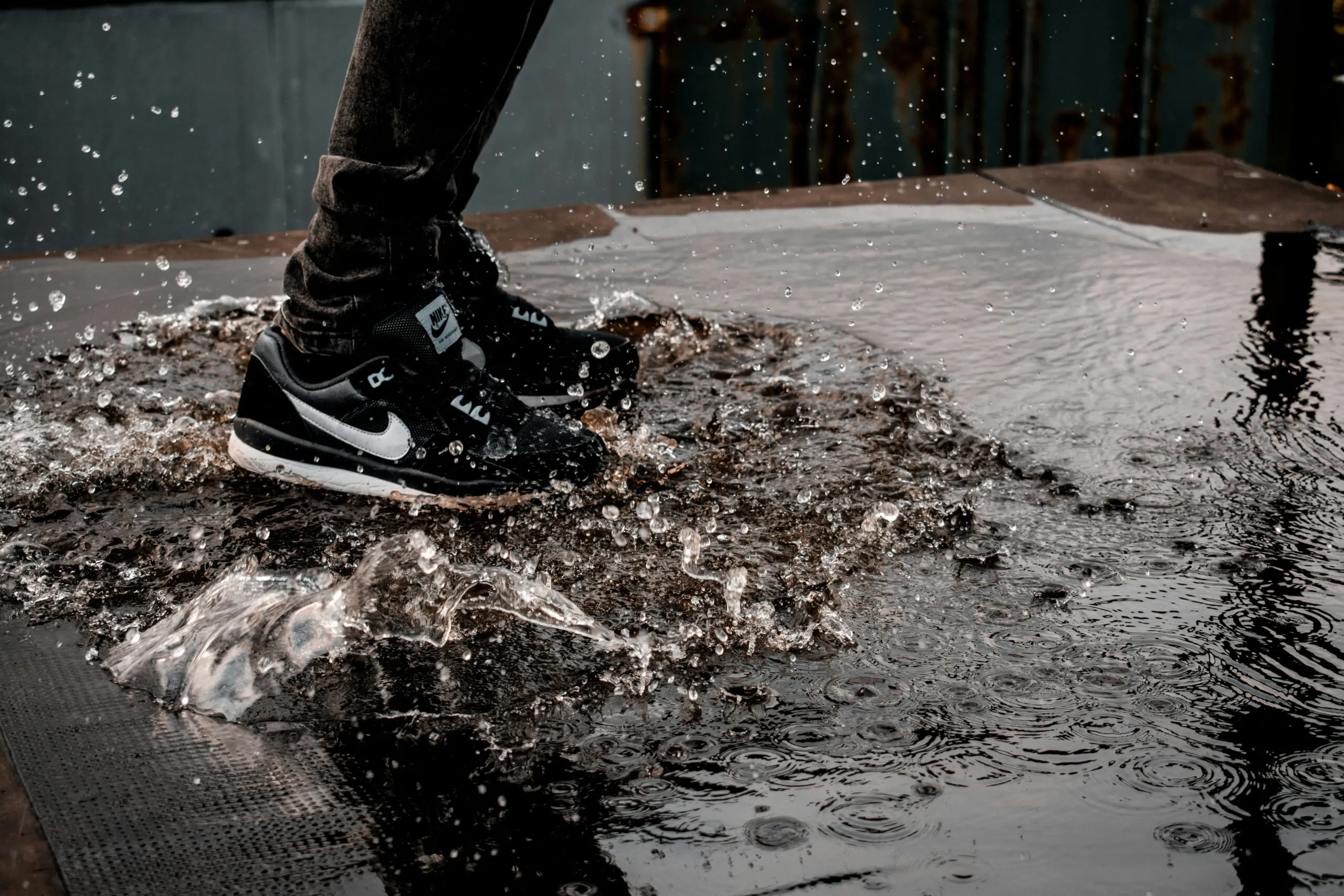 man splashing water on ground