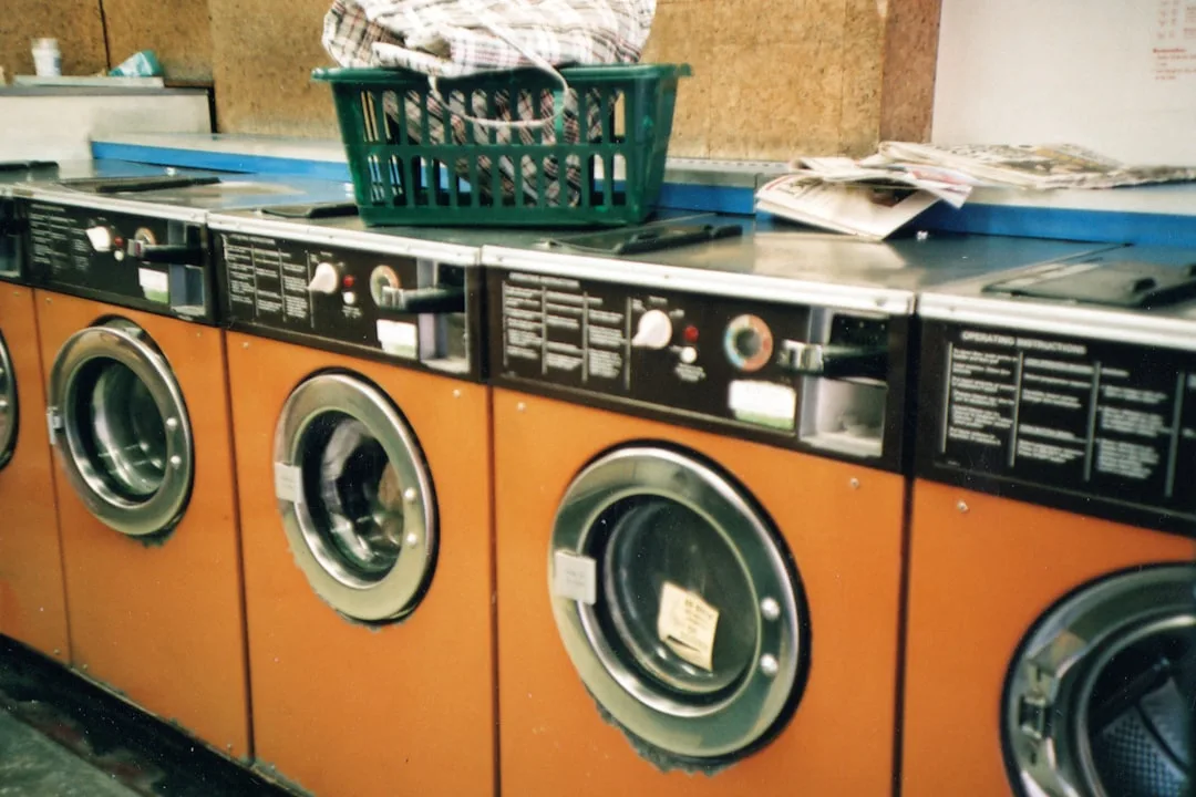 green plastic basket on front load washing machine