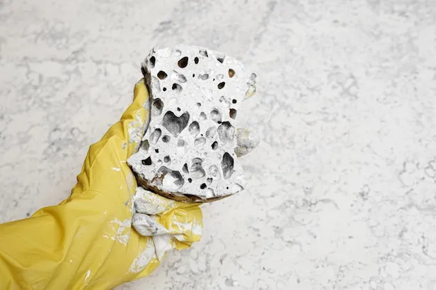 Applying white paint to the canvas with a sponge