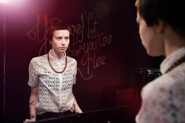 Close-up of a beautiful young woman looking at mirror