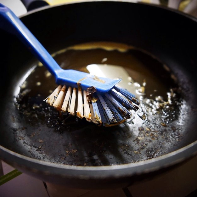 Close-up of brush in pan