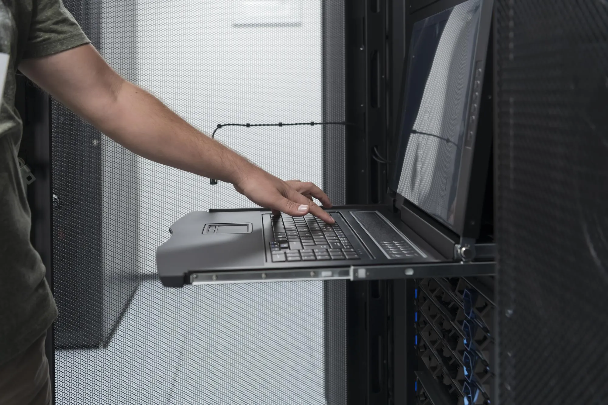 Close up on Data Center Engineer hands Using keyboard on a supercomputer Server Room Specialist Facility with Male System Administrator Working with Data Protection Network for Cyber Security