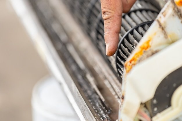 Close up of finger repairman point to dirty inside compartments air conditioner