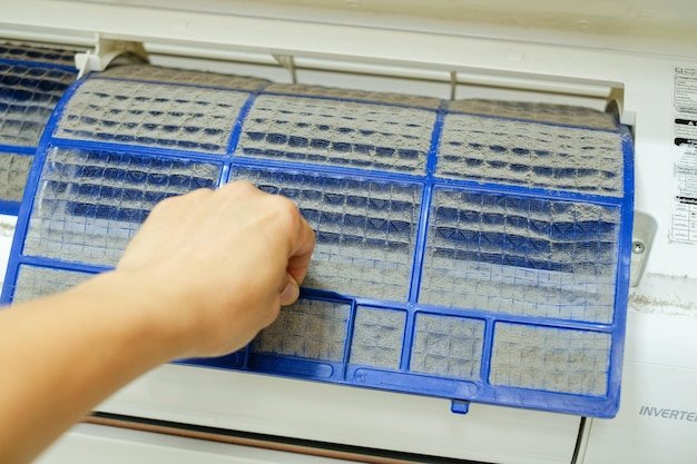 Close up hand holding the air filter with a lot of dust for service