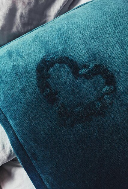 Close-up of heart on blue textile