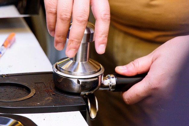 Close-up of person preparing coffee grinder