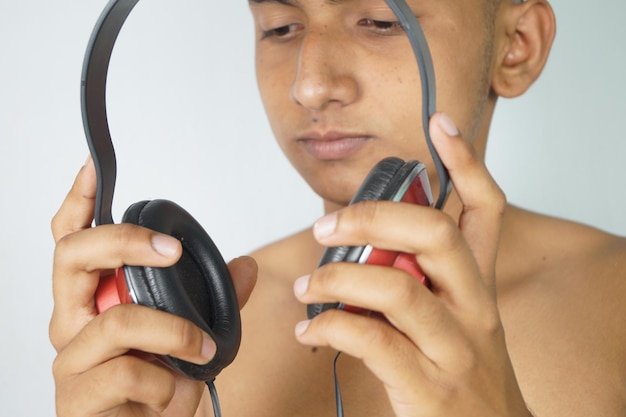 Close-up portrait of shirtless man holding camera