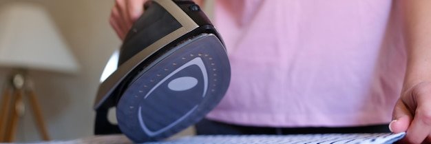 Closeup of woman housewife ironing bed linen using steam iron woman doing housework