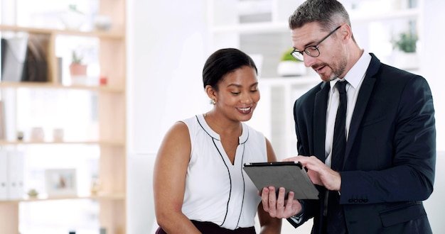 Corporate meeting and business people on tablet in office for finance consulting budget review and planning Collaboration team and man with woman on digital tech for research website or proposal