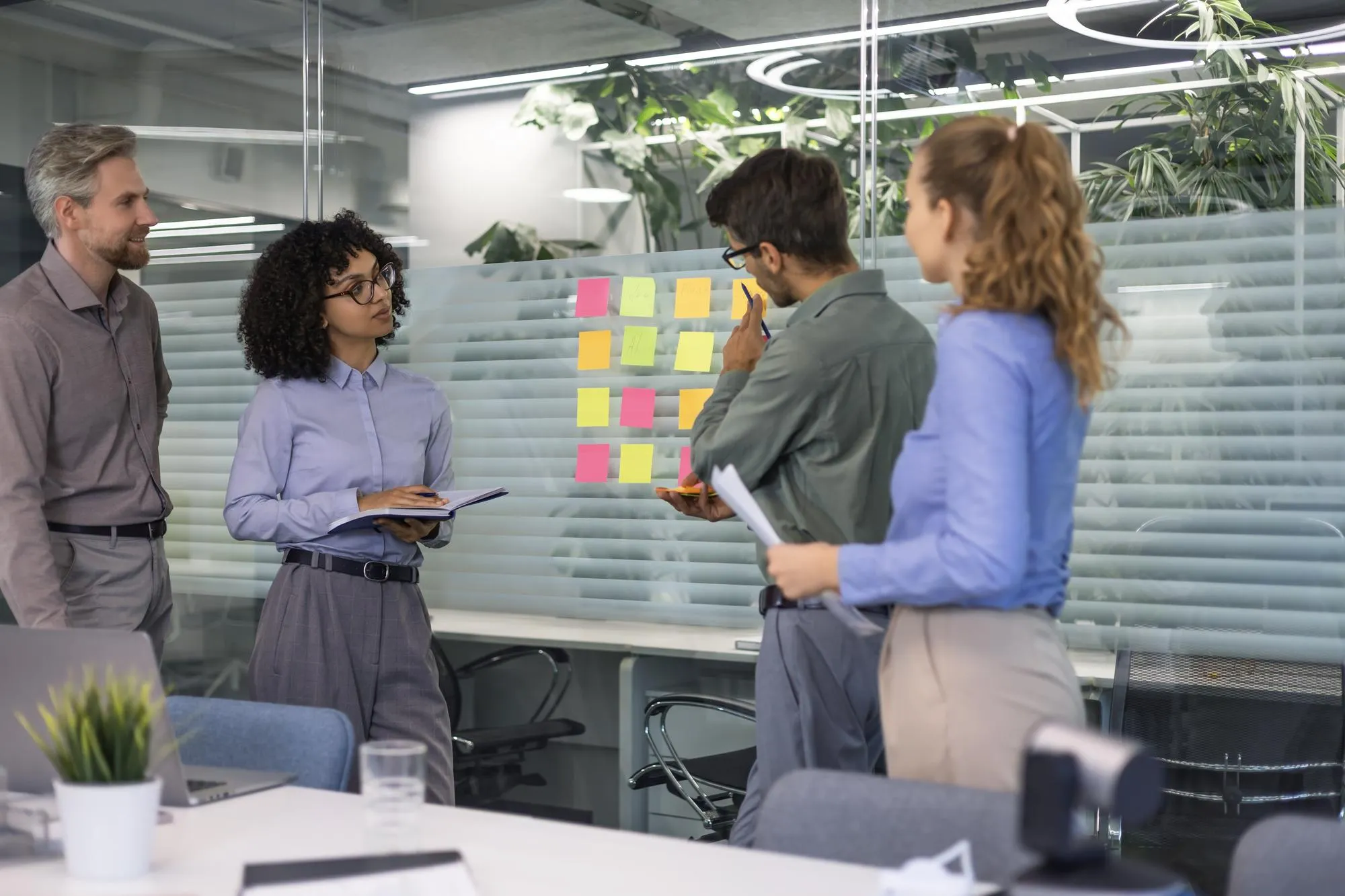 Creative group or business people planning innovation with sticky notes on glass wall