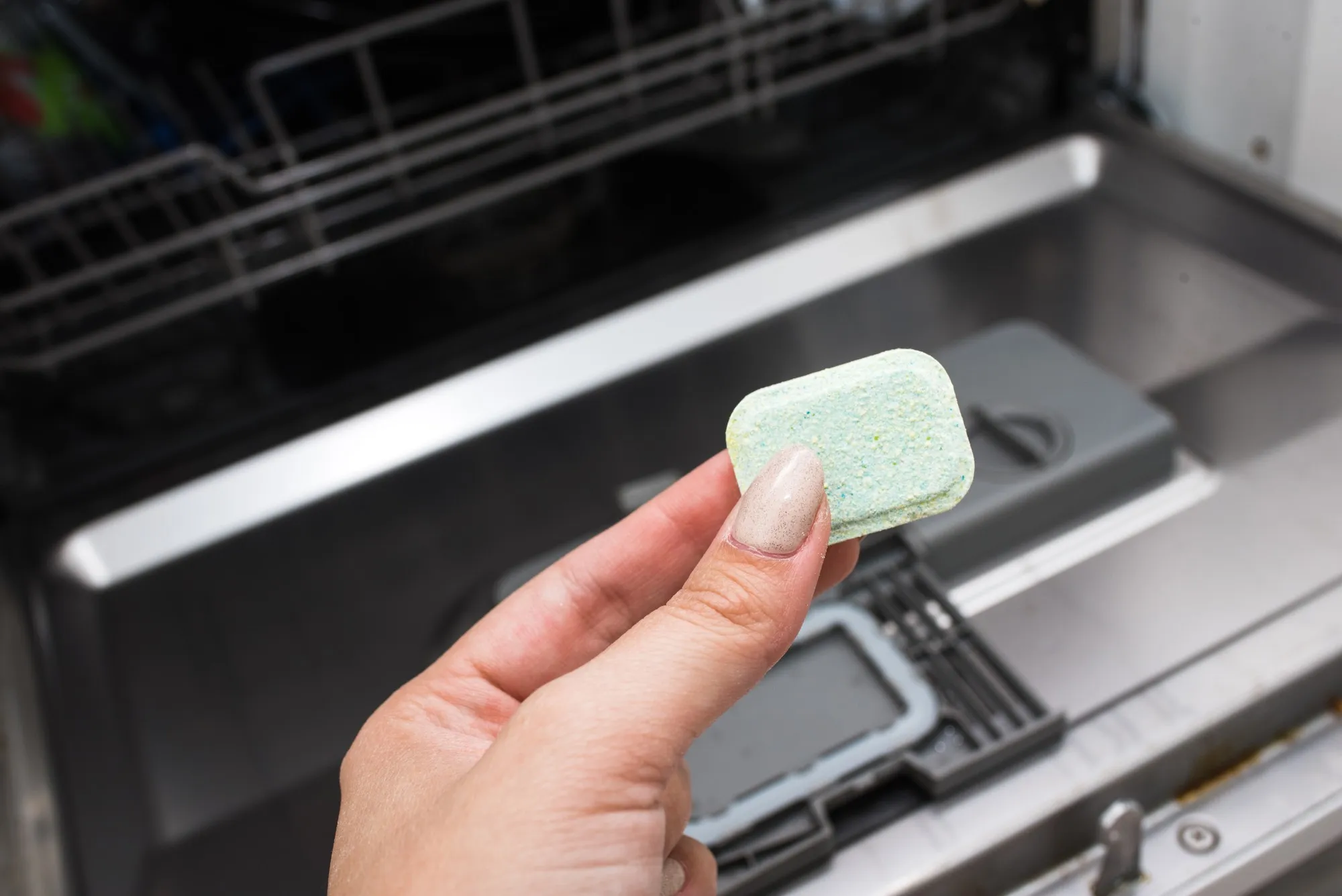 Dishwasher tablet. Cleaning the kitchen. Washing dishes in the dishwasher