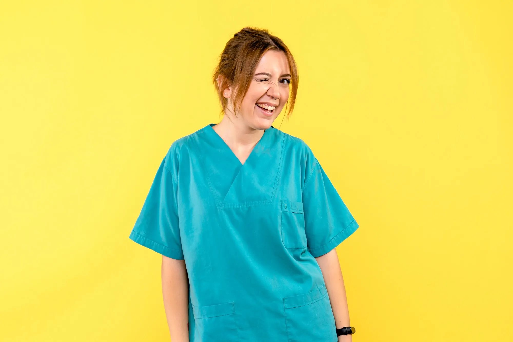 Front view female doctor winking on yellow space