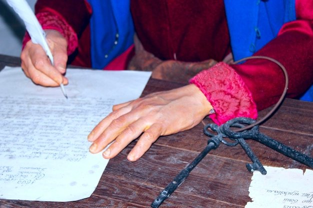 Hands of clerk writing old letter Wax figure of old clerk in museum of Baturin Old Ukrainian clerk with pen in his hand