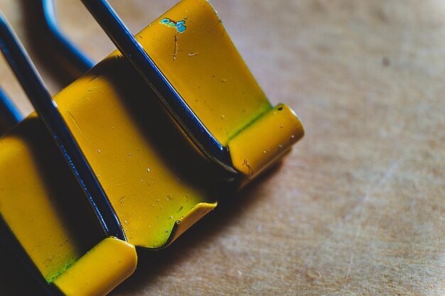 High angle view of yellow bulldog clip on table