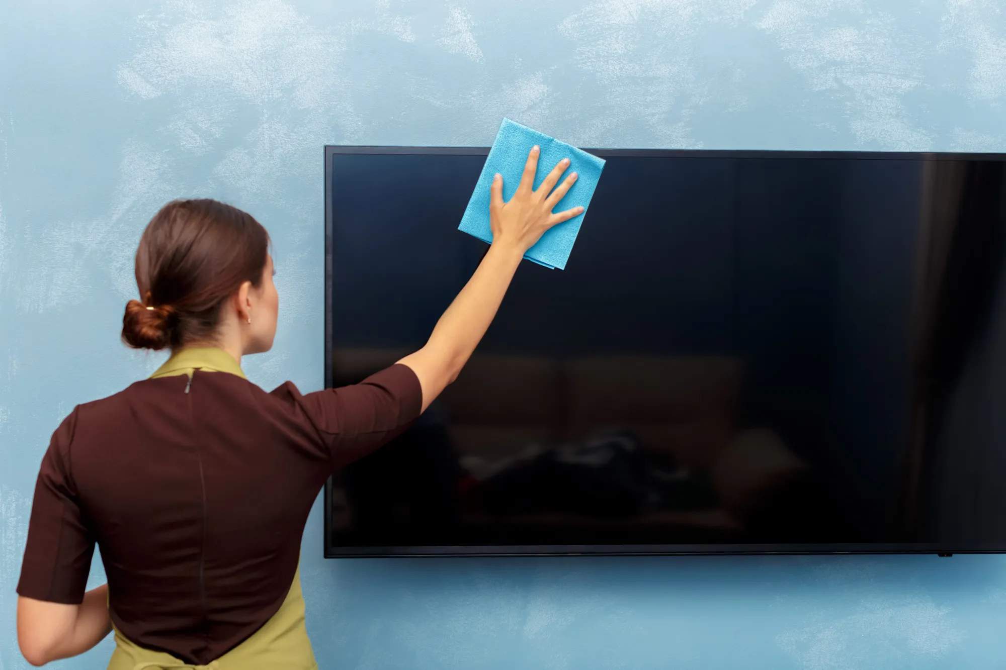 Housekeeper cleaning a hotel room