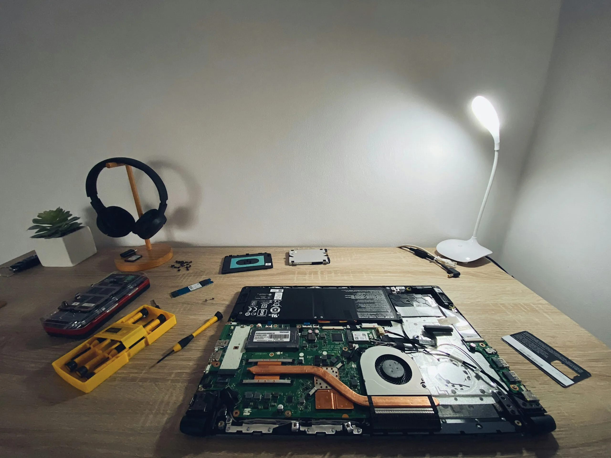 a table with a laptop and headphones on it