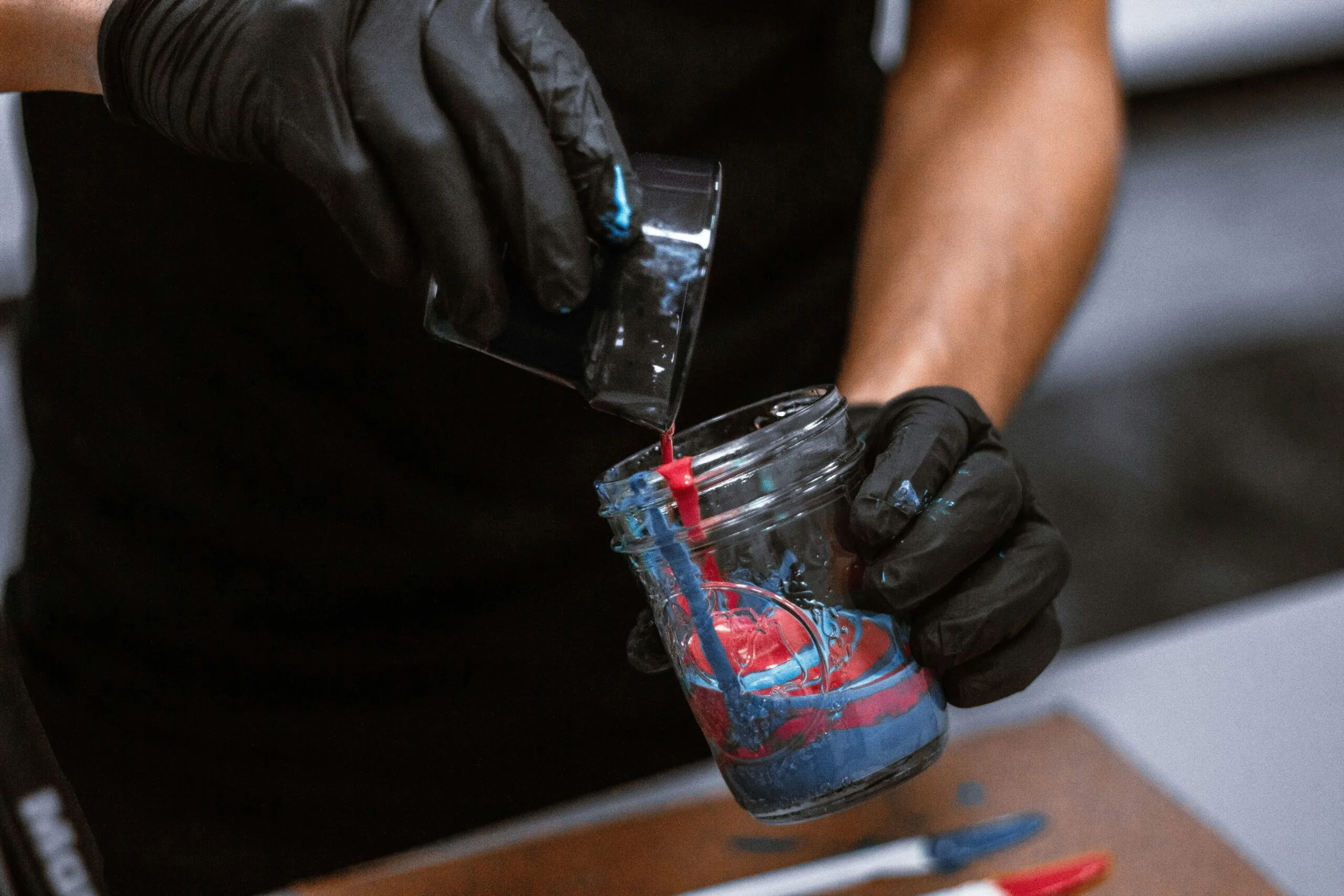 shallow focus photo of person holding glass cup