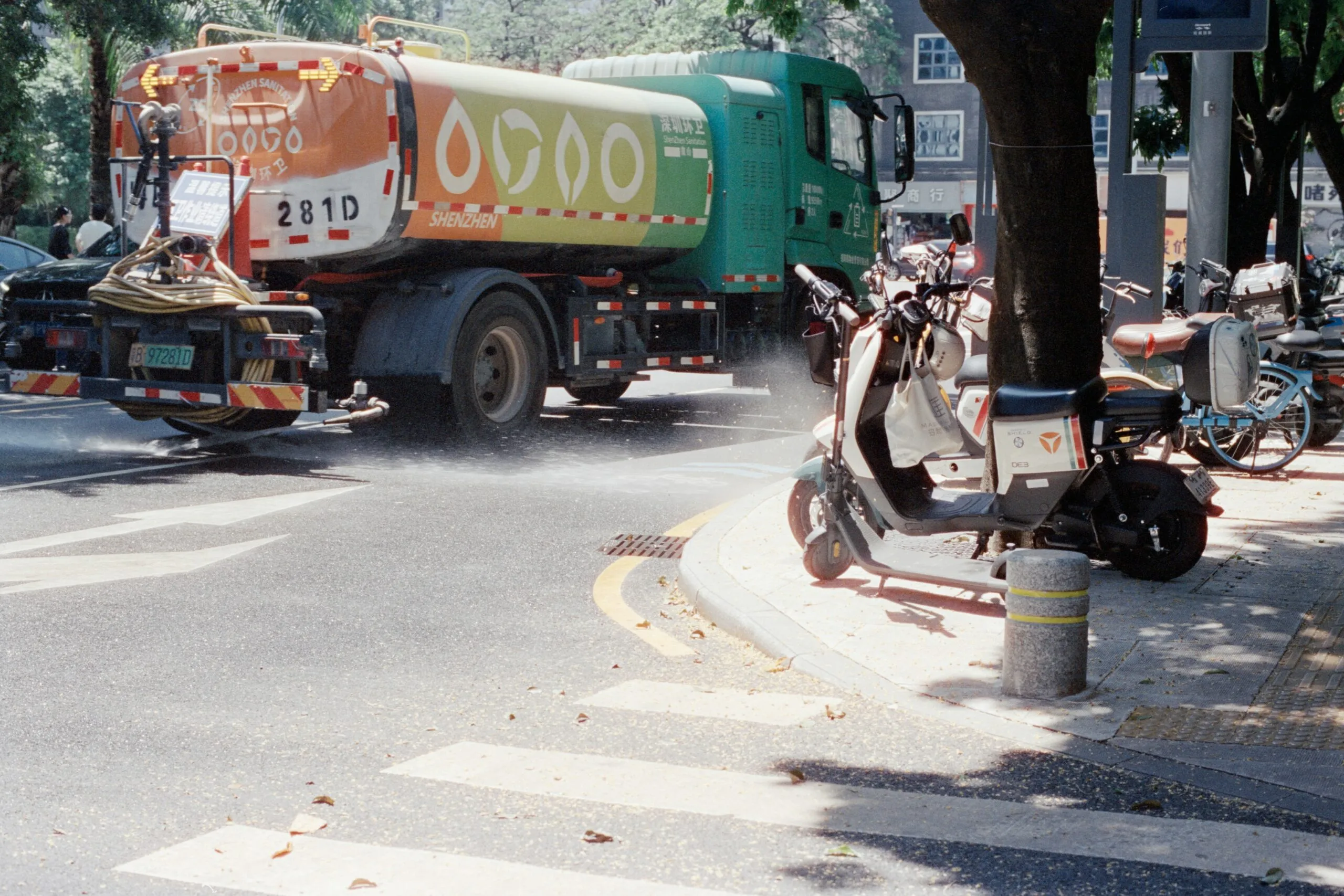 Water truck spraying water on city street