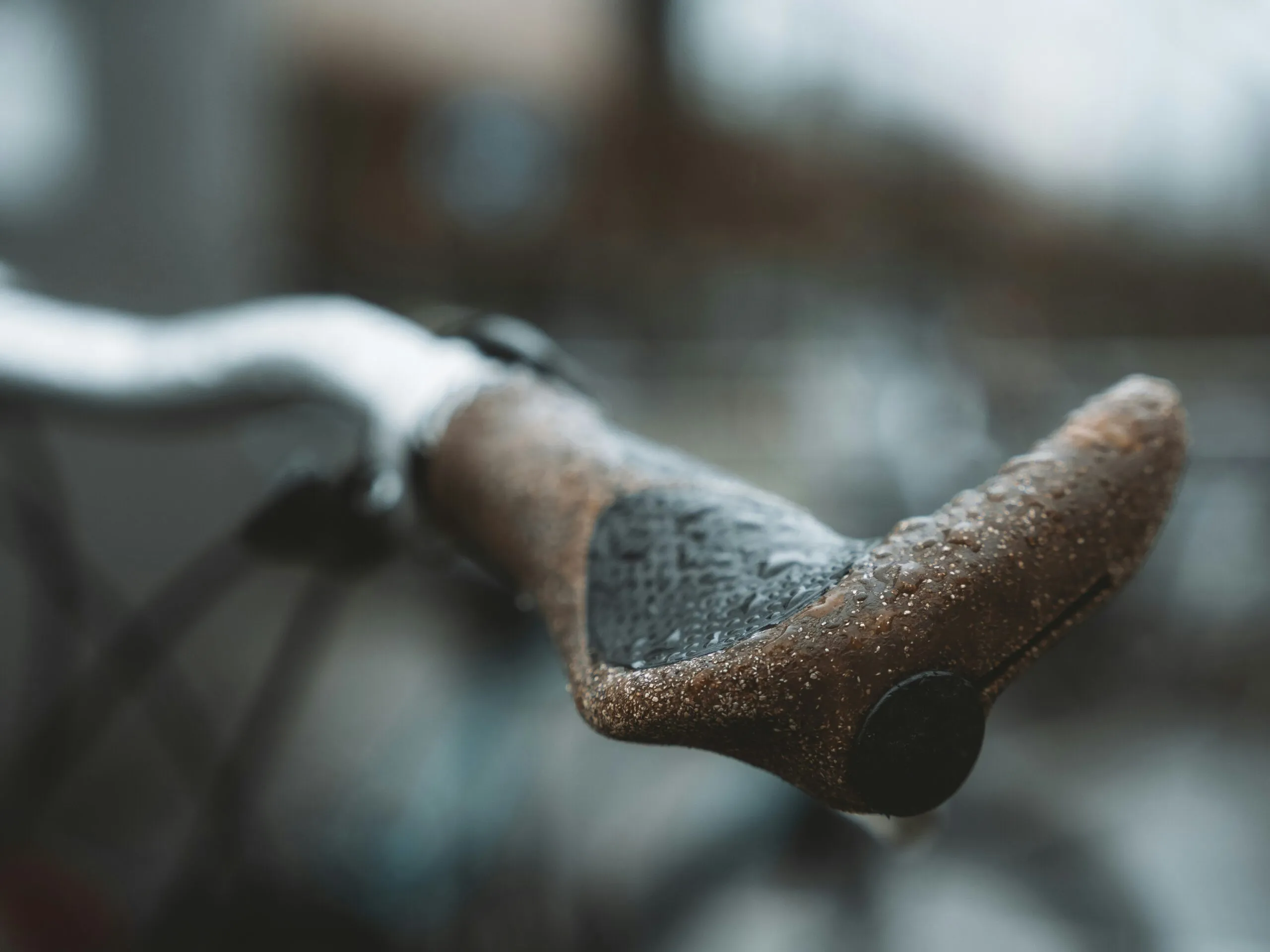 a close up of a bike handle with snow on it