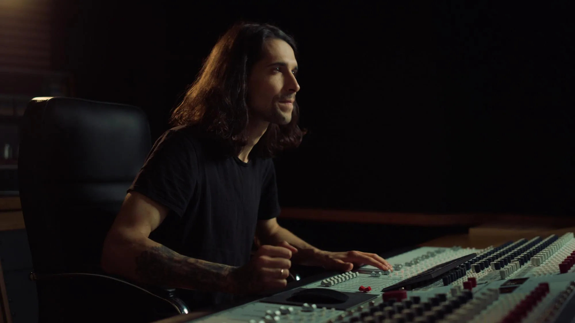 Joyful man gesticulating in music studio Happy guy listening to music indoor