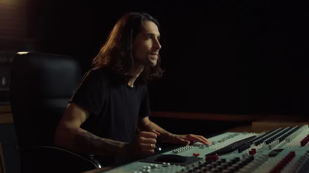 Joyful man gesticulating in music studio Happy guy listening to music indoor