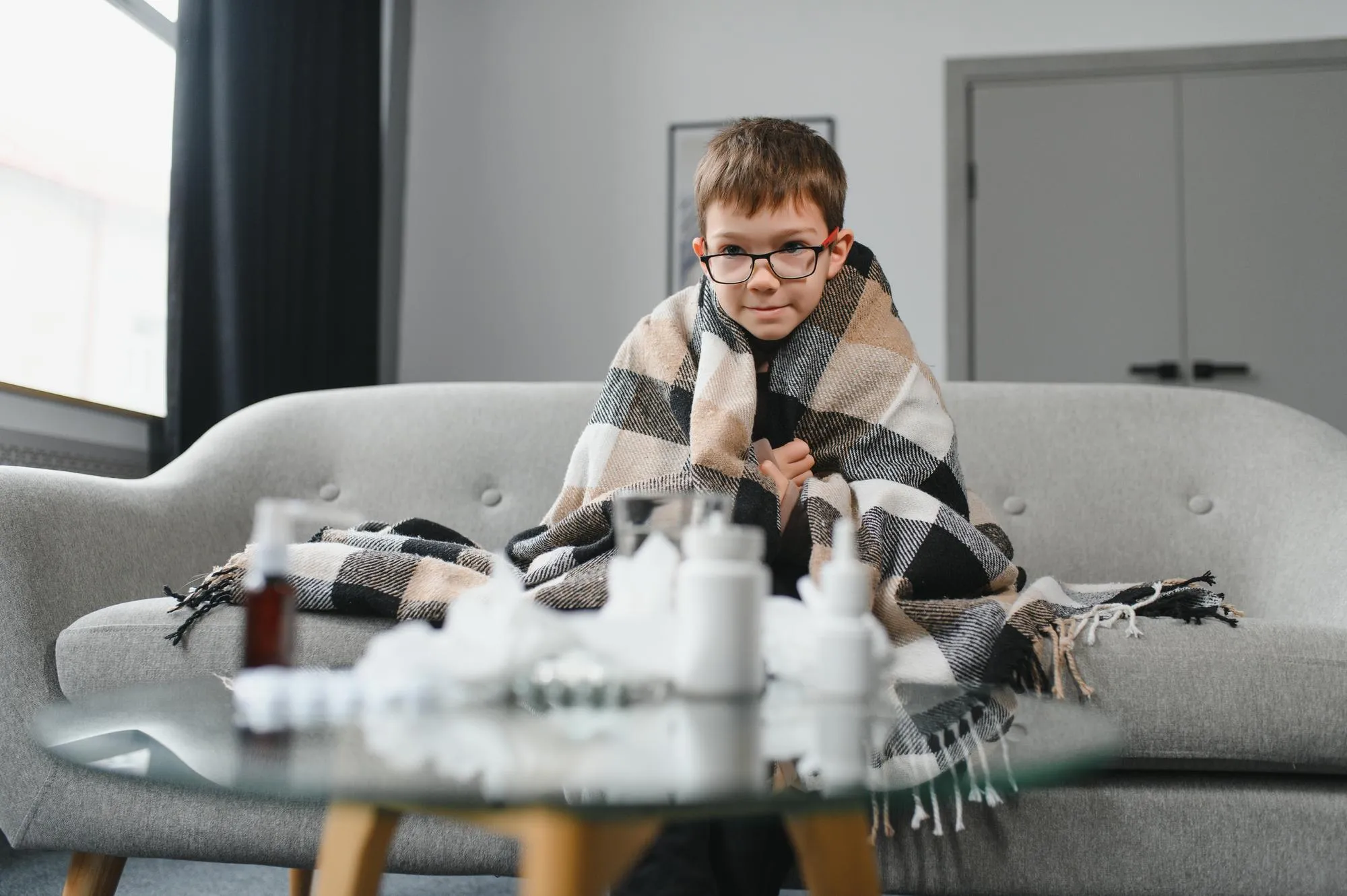 little child boy is sick A thick scarf is wrapped around her neck Treatment of colds and flu sick child boy