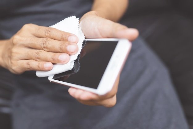 Midsection of man using mobile phone