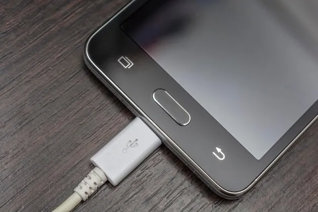 Mobile smart phones charging on wooden desk