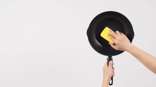 pan cleaning man hand on white background cleaning the non stick pan with handy dish washing sponge