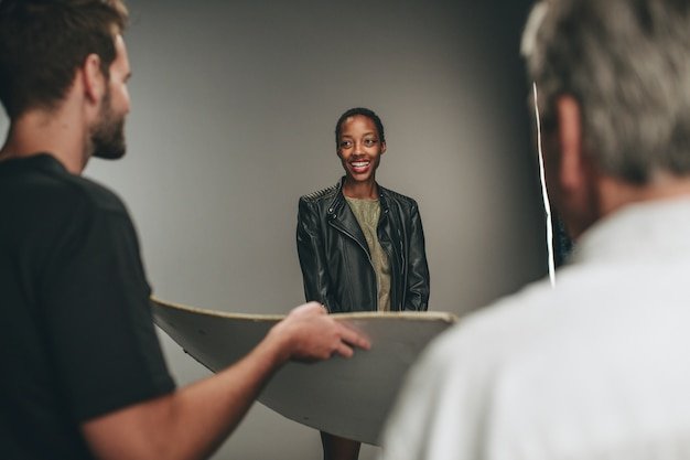 Photographer assistant holding a reflector