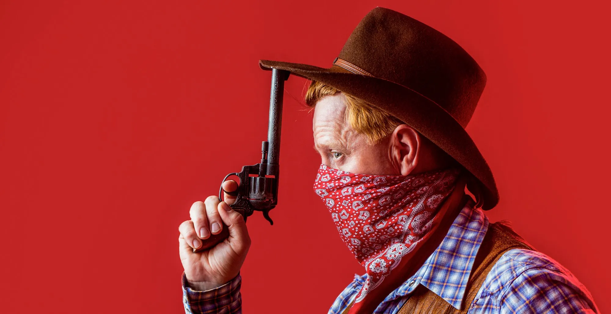 Portrait of cowboy in hat. Portrait of man wearing cowboy hat, gun. Portrait of a cowboy. West, gun