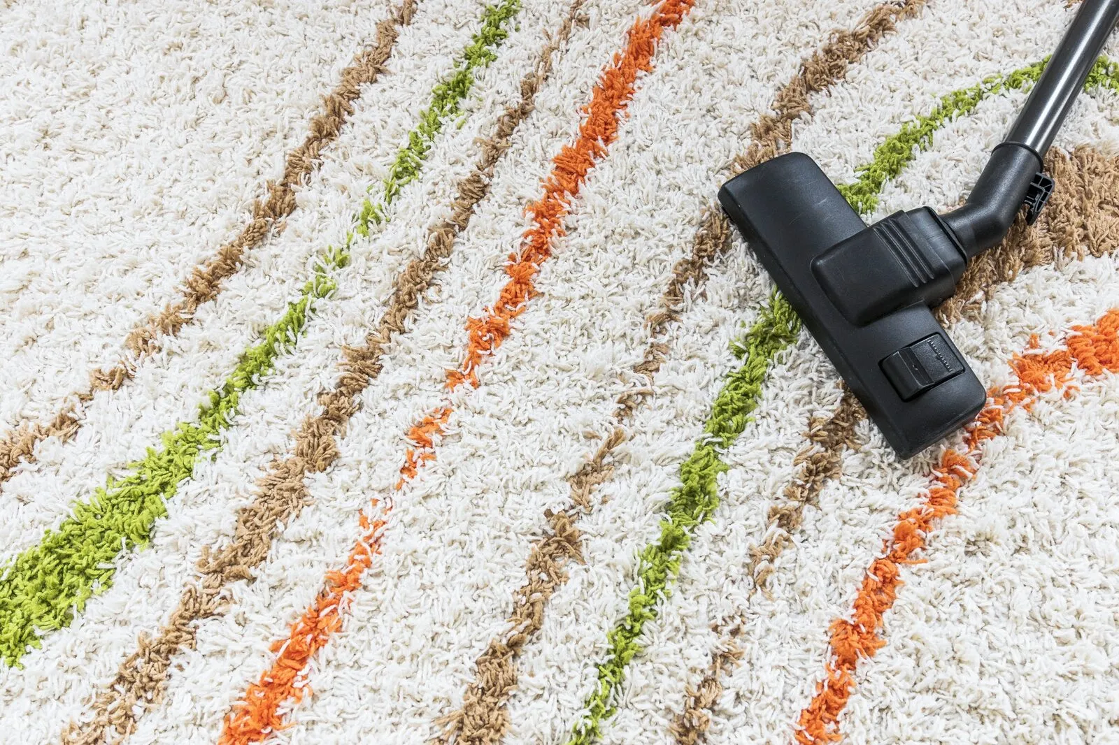 Top view arrangement with vacuum cleaner on carpet