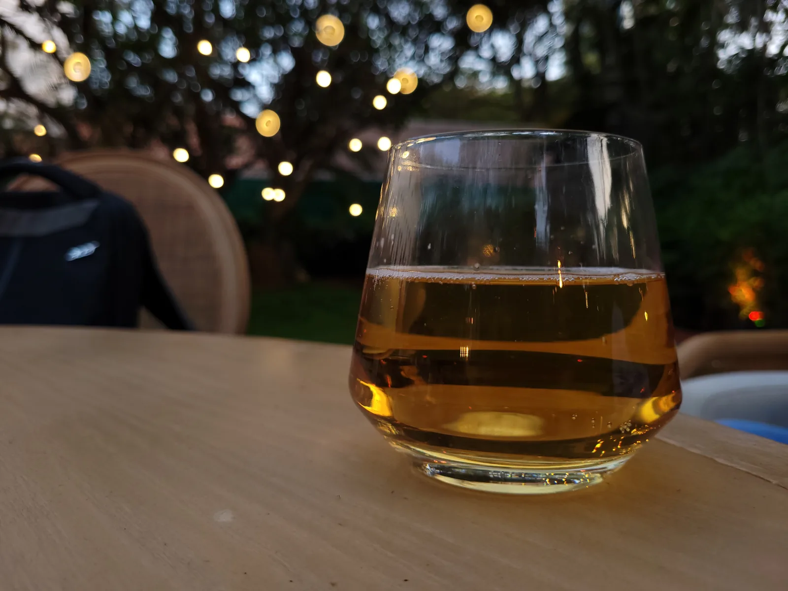 Brimming with golden amber liquid, exudes an air of sophistication and warmth at the lively party. The rich colour of the whiskey catches the light, creating a mesmerizing play of shadows and reflections.