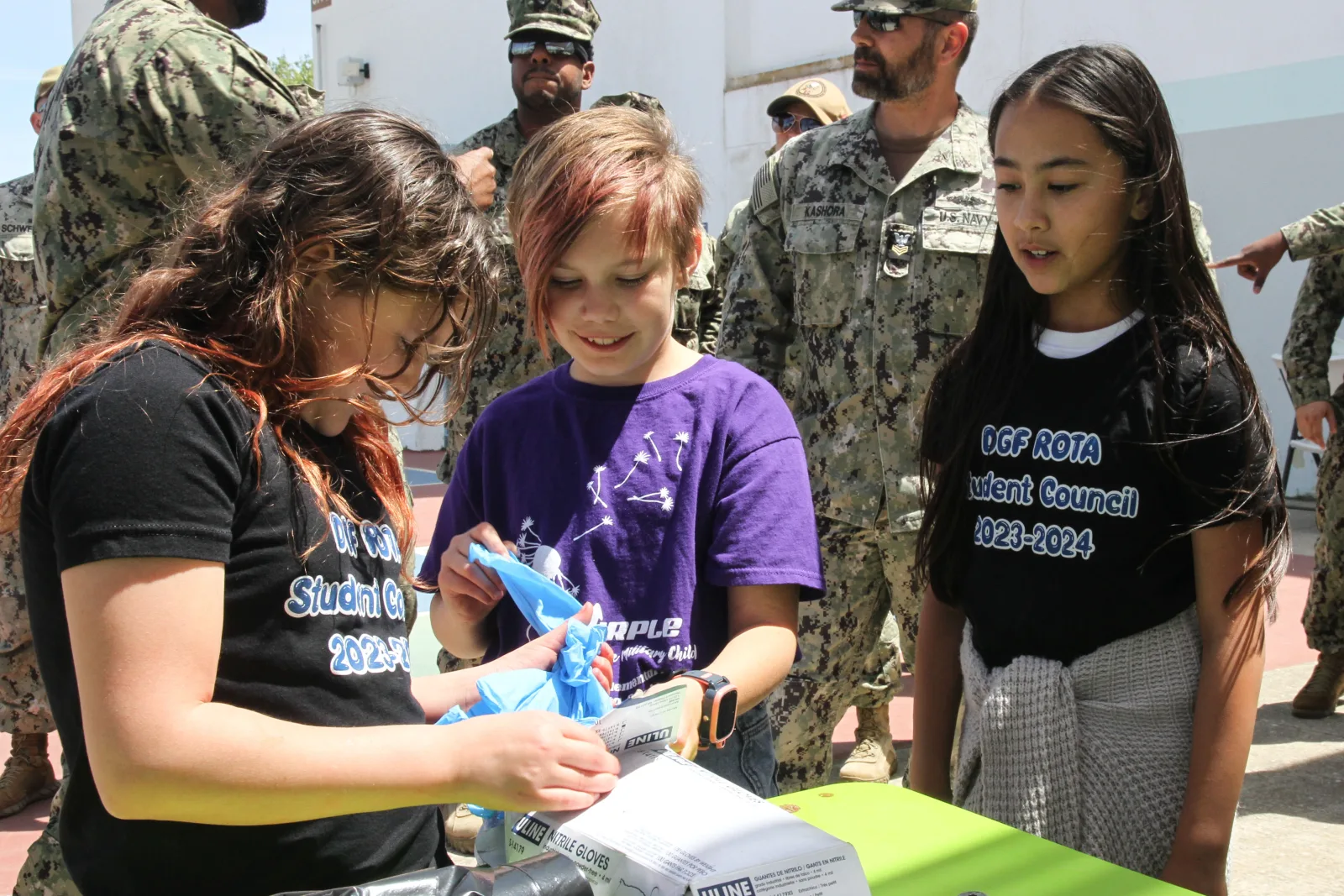 240424-N-GA645-1018 NAVAL STATION ROTA, Spain (April 24, 2024) Students from the school’s Anchored4Life student ambassador program and student council collect their gloves and cleaning supplies at Rota Elementary School, April 24, 2024. The students along with Sailors from the First Class Petty Officer Associations of Naval Station (NAVSTA) Rota and Navy Mobile Construction Battalion (NMCB) 11 collaborated on a beautification project at the school. (U.S. Navy photo by Courtney Pollock)