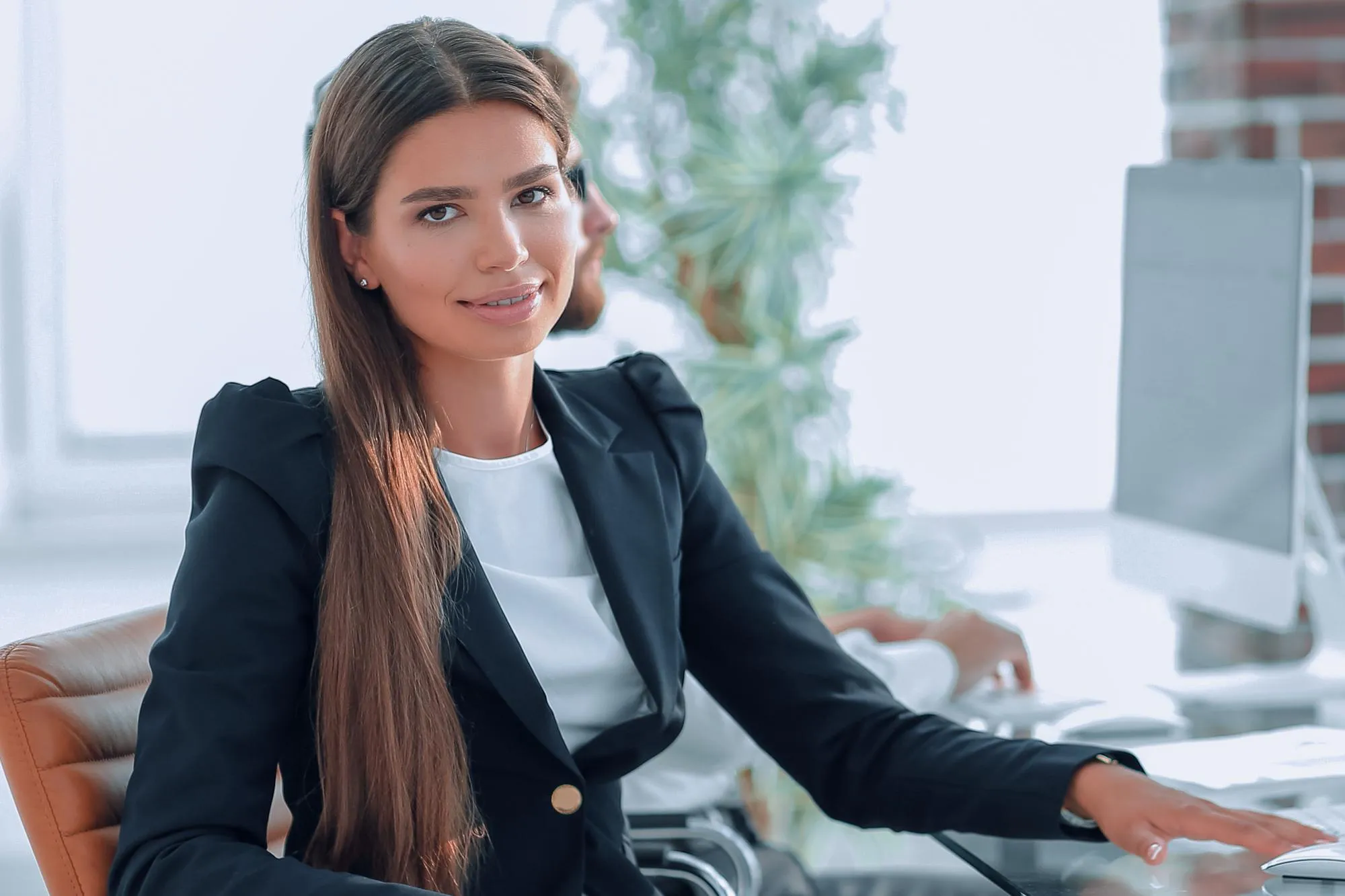 Young business woman sitting at desk