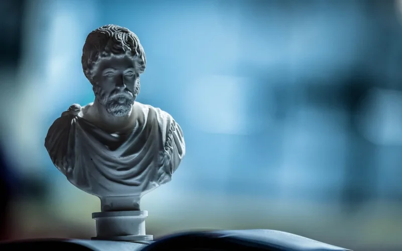 Artistic arrangement of classical busts and candle, creating a serene, elegant setting.