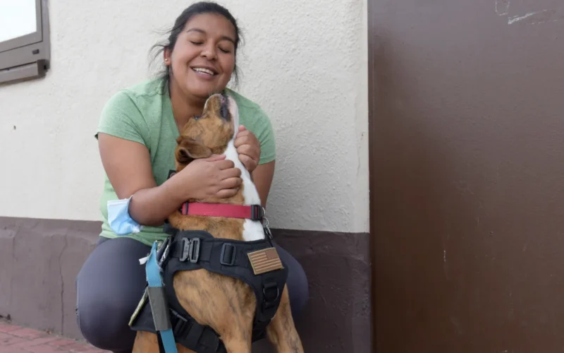 U.S. Air Force Staff Sgt. Barbara Cordero, 86th Medical Group surgical technician, hugs her emotional support dog, Goliath, at Ramstein Air Base, Germany, Sept. 7, 2021. Cordero brought Goliath to the pods to support military members during Operation Allies Refuge. (U.S. Air Force photo by Airman 1st Class Madelyn Keech)