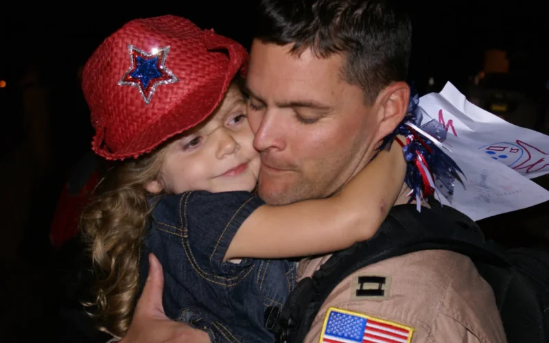 Captain Michael Capozzi, a pilot with the 7th Airlift Squadron, gets a big hug from his daughter during the squadron's return July 7 to McChord Air Force Base, Wash. More than 150 Airmen from the squadron were greeted by family and friends here after more than four months deployed in support of operations Enduring and Iraqi Freedom.