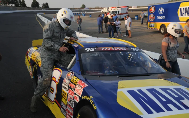 Staff Sgt. Brett Myers, 92nd Security Forces Squadron military working dog handler, gets in a NAPA team race car at the Spokane County Raceway in Airway Heights, Wash., Aug. 23, 2013. Throughout the week, several personnel from Fairchild got the opportunity to ride in the stock cars for three laps around the track. (U.S. Air Force photo/Airman 1st Class Sam Fogleman)