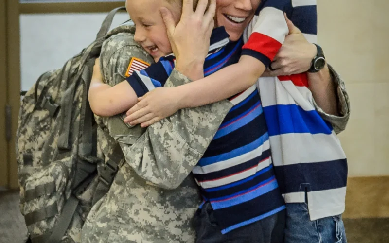North Dakota National Guard Capt. Nicolette Daschendorf, of the Fargo-based 231st Brigade Support Battalion Logistical Support Element (BSB LSE), hugs her children after her arrival at Bismarck Airport on July 21, 2015 after a nearly yearlong deployment overseas. The group of fifteen Soldiers arrived on two separate flights this evening, with twelve landing at Fargo’s Hector International Airport and the other three at Bismarck Airport. Daschendorf served as the unit’s commander. (U.S. Army National Guard photo by: Staff Sgt. Brett Miller/Released)