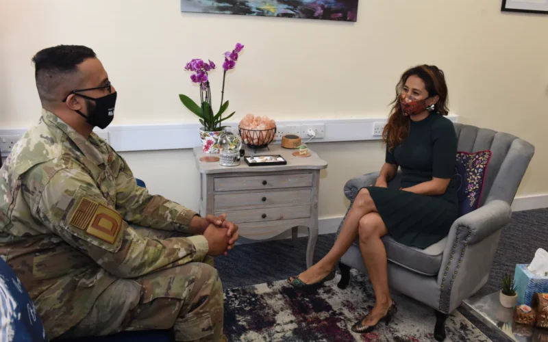 U.S. Air Force Staff Sgt. Abdul Sadiq, 100th Security Forces Squadron and Square D Character, Culture and Community administrative support, chats with Dr. Karen Kuemerle-Pinillos, 100th Air Refueling Wing licensed clinical social worker, in the BRIEF Therapy area in the DC3 building at RAF Mildenhall, England, Aug. 2, 2021. The program – Behavioral solutions Refined by Identified problems for Emotional health and Focused goals –helps clients with issues such as stress, anger management and relationship issues. (U.S. Air Force photo by Karen Abeyasekere)