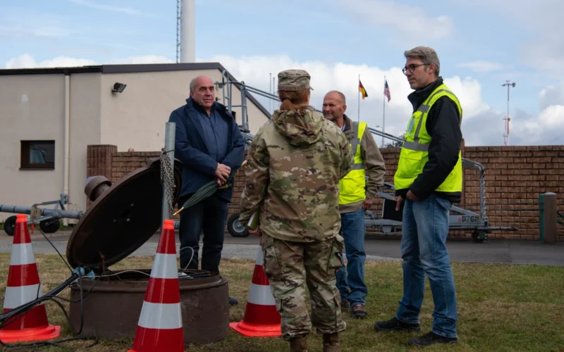 U.S. Air Force 1st Lt. Merrick Choate-Houston, 86th CES Installation Management Flight deputy, discusses cleaning an oil-water separator on Ramstein Air Base, Germany, Oct. 13, 2021. Choate-Houston is responsible for identifying, developing, implementing and executing all civil engineer requirements for the sustainment and reconstitution of pods through contracted means. (U.S. Air Force photo by Airman Jared Lovett)
