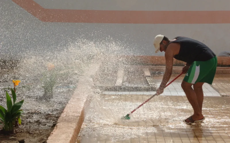 An Iraqi employee cleans the pool deck at the Jadida public swimming pool located Eastern Baghdad, Iraq, June 7, 2008. The pool staff is preparing for the grand opening on the newly renovated facility.