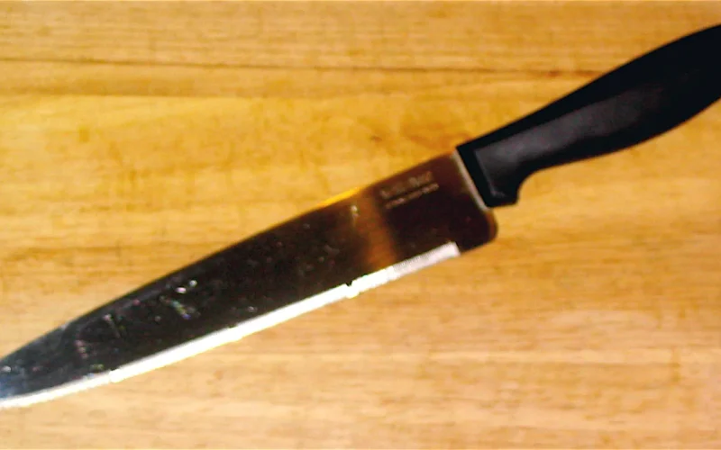 Wiltshire stay-sharp eight-inch chef's knife, with serrated blade, on wooden cutting board